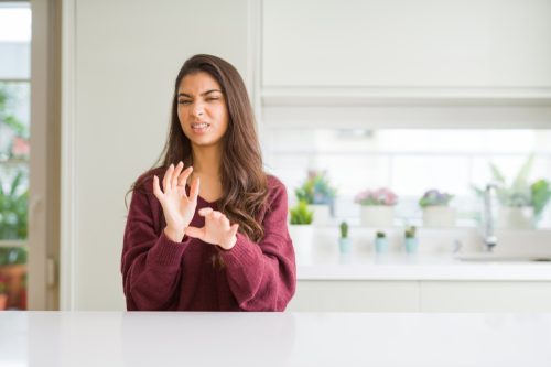 Woman Looking Disgusted in Kitchen