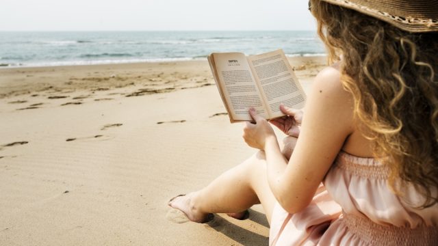 Woman Reading on the Beach