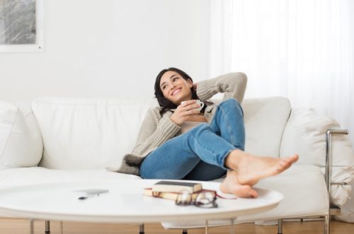 Woman Relaxing on Couch with Tea