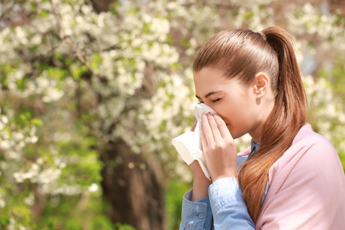 Yes Your Allergies Are Worse This Year Here S Why Best Life   Woman Sneezing Seasonal Allergies 