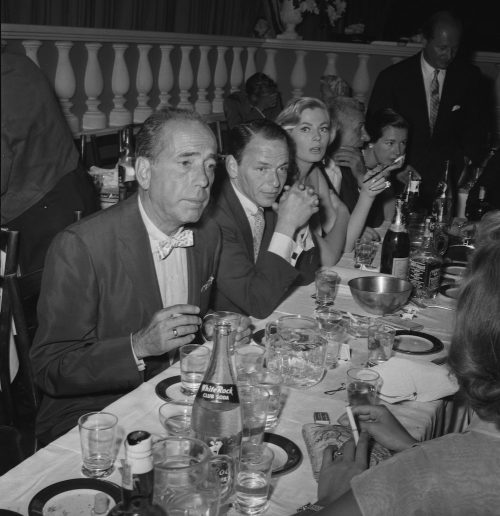 Humphrey Bogart, Frank Sinatra, and Anita Ekberg at Romanoff's Restaurant in 1955