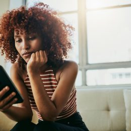 Woman, phone and home sofa while online for communication on social media mobile app chat. Bored person with smartphone typing email, blog post or search on internet waiting on slow wifi connection