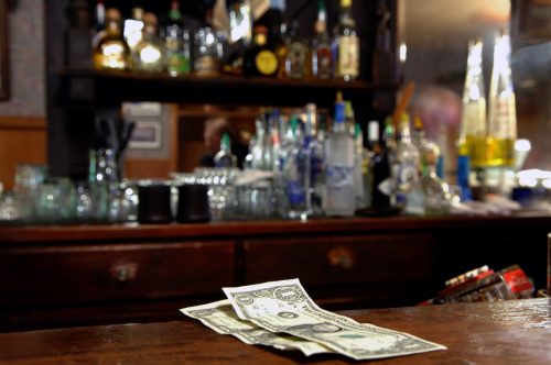 Two Dollar Tip Left For Bartender in Rustic Bar. Very shallow depth of field.