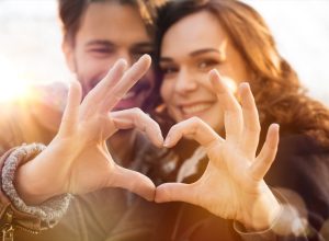 Closeup of couple making heart shape with hands
