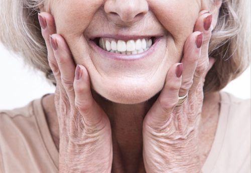 older woman with dentures smiling and showing teeth