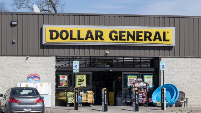 A Dollar General storefront with a car parked near the door