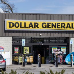 A Dollar General storefront with a car parked near the door
