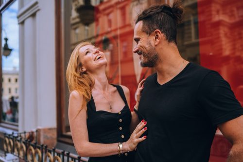 man and woman laughing on the street