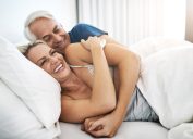 man and woman cuddling in bed in the morning