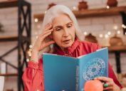 older woman reading astrology book