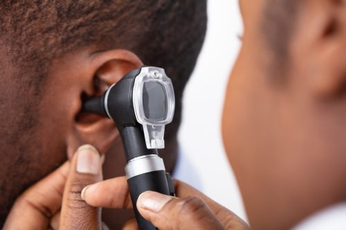 Doctor Examining Male Patient's Ear