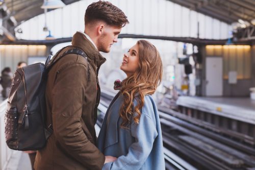 young couple saying goodbye at the train station