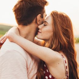 Couple hugging in a field