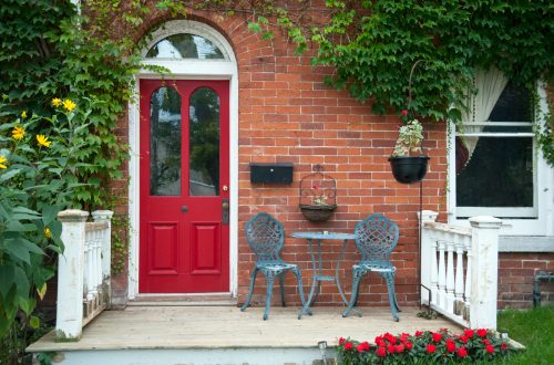 A front porch with a red door