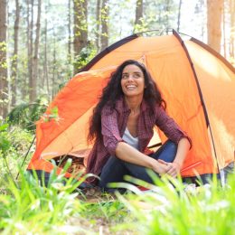 Young woman camping in the forest
