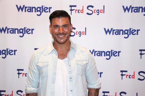 Jax Taylor posing and smiling at an event