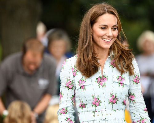 Kate Middleton outside wearing a floral dress and smiling