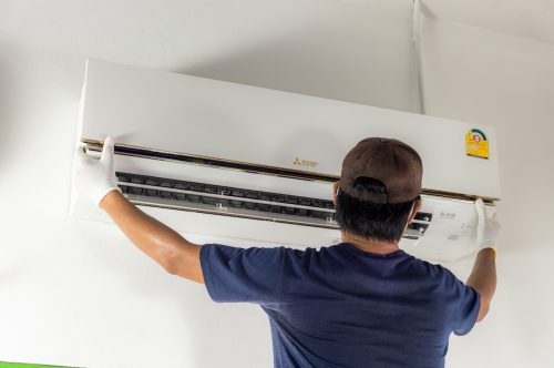 Man installing a Mitsubishi Electric air conditioner