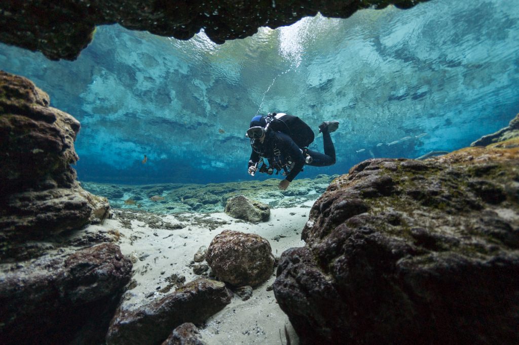 Person snorkeling in underwater caves at Ginnie Springs, Florida.