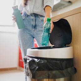 Young woman recycling garbage at home, young woman recycling garbage. Sustainability concept