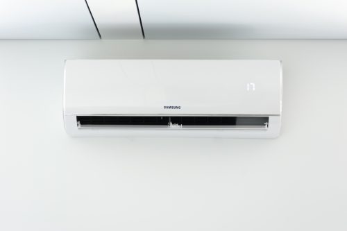 white Samsung air conditioner on white wall
