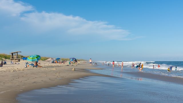 People relax on the beach and swim in the surf of the lifeguarded beach on Ocracoke Island, part of the Cape Hatteras National Seashore.