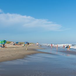 People relax on the beach and swim in the surf of the lifeguarded beach on Ocracoke Island, part of the Cape Hatteras National Seashore.