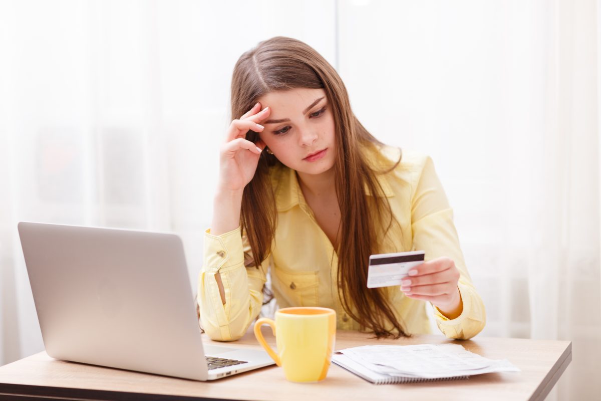 Young woman at laptop with credit card