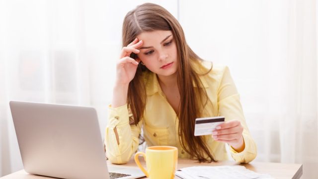 Young woman at laptop with credit card