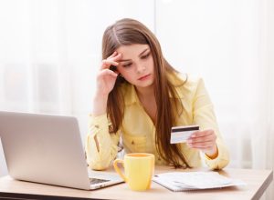 Young woman at laptop with credit card