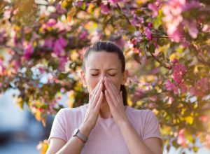 woman sneezing from allergies
