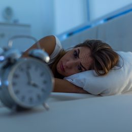 Woman with insomnia lying in bed
