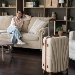 Woman guest on couch with suitcase