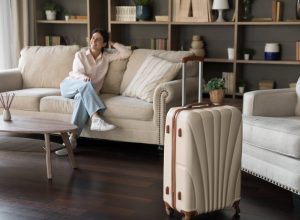 Woman guest on couch with suitcase
