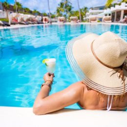 woman drinking cocktail at all-inclusive resort