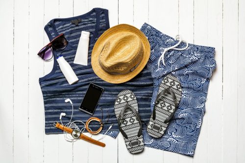 Men's blue beach outfit with swim trunks, flip flop sandals, and hat
