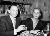 Frank Sinatra and Lauren Bacall at a party in 1957