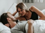 Romantic moment: Happy couple in love in the bed - Stock image