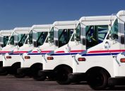 Idaho Falls, Idaho Jul. 14, 2010 A row of US Postal service trucks, parked waiting to deliver the mail.