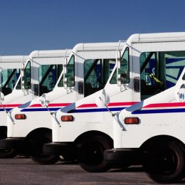 Idaho Falls, Idaho Jul. 14, 2010 A row of US Postal service trucks, parked waiting to deliver the mail.