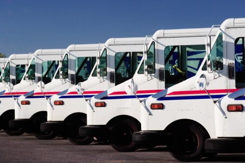Idaho Falls, Idaho Jul. 14, 2010 A row of US Postal service trucks, parked waiting to deliver the mail.
