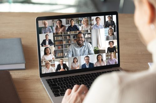woman joining a virtual team meeting from her laptop