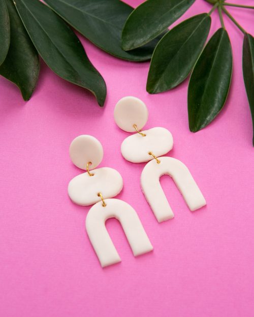 White Polymer Clay Statement Earrings on pink background with leaves