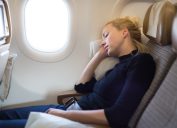 A woman sleeping on an airplane.