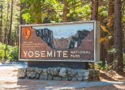Entrance sign to Yosemite National Park welcoming travelers.