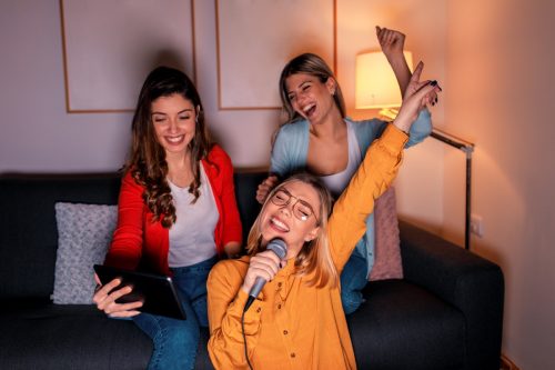 Three Girlfriends Doing Karaoke