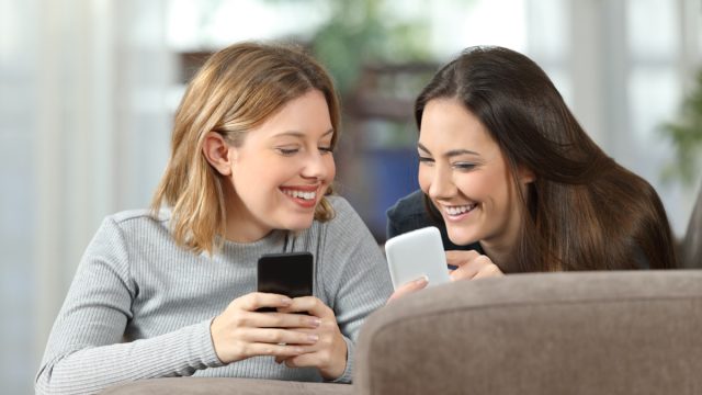 Two Girls Scrolling on Phones