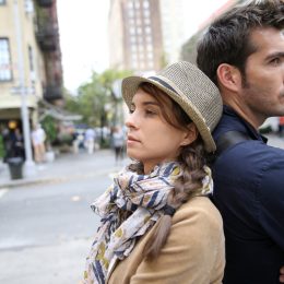 Two People Standing Back to Back