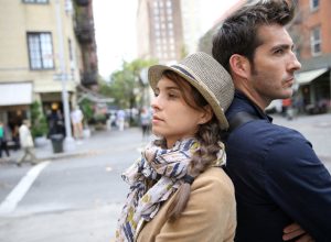 Two People Standing Back to Back