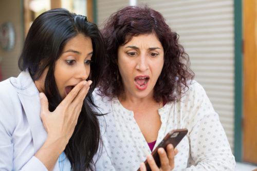 Two Women Gasping at Phone